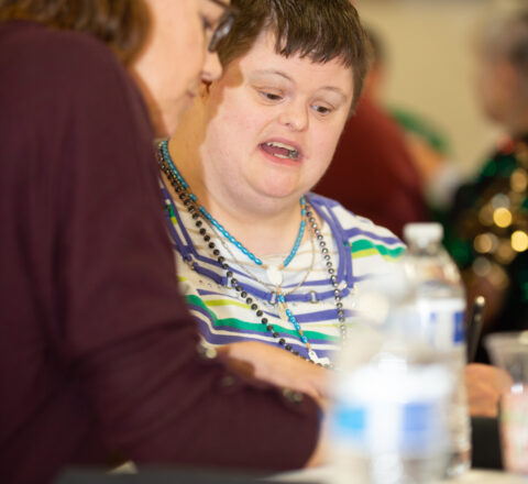 Gabriel Homes Board Member Karen Chapman (left) with a resident (right).