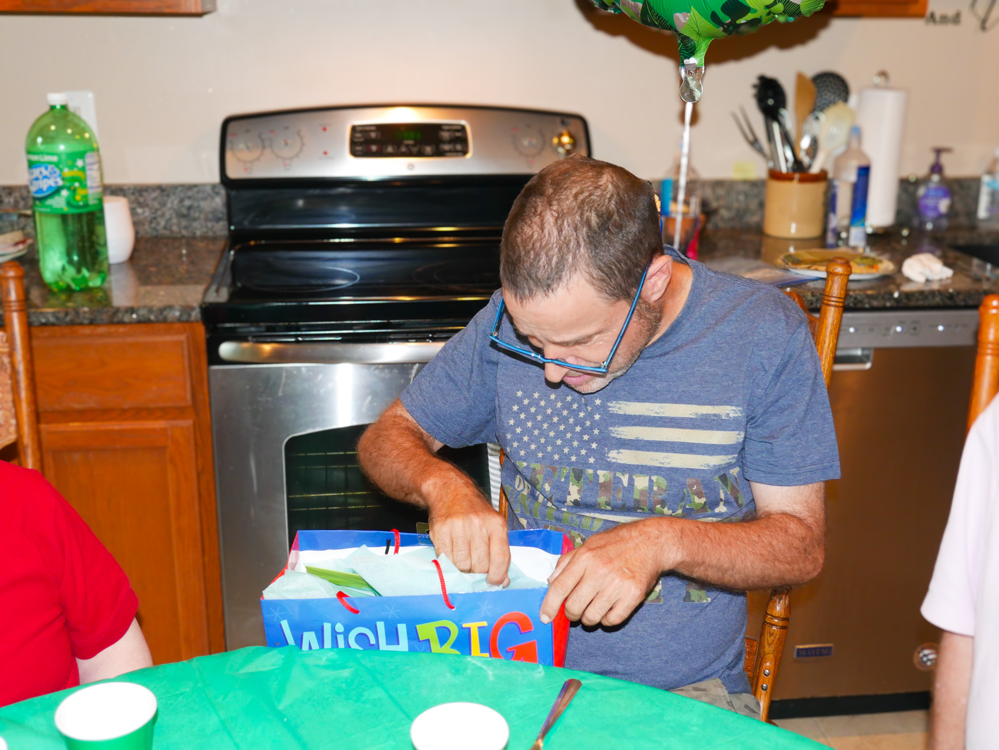 Gabriel Homes resident opening gift bag at birthday party.