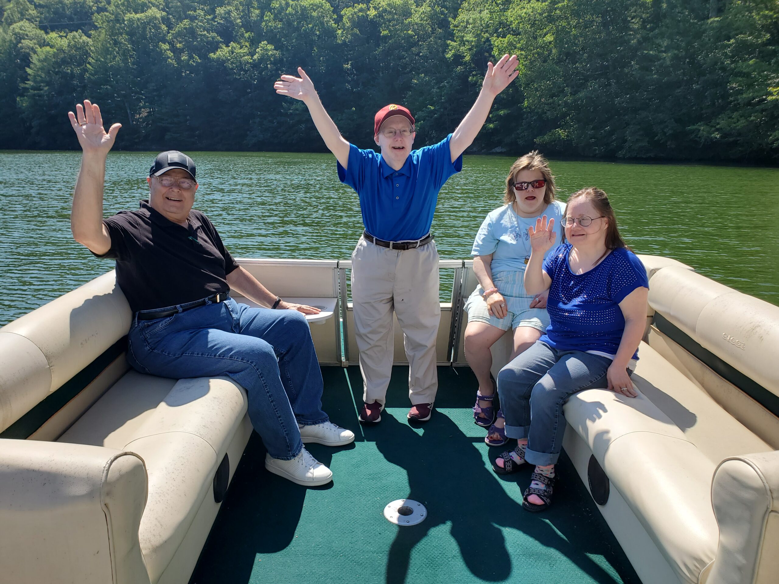 Gabriel Homes residents celebrating being on a boat at a local lake.