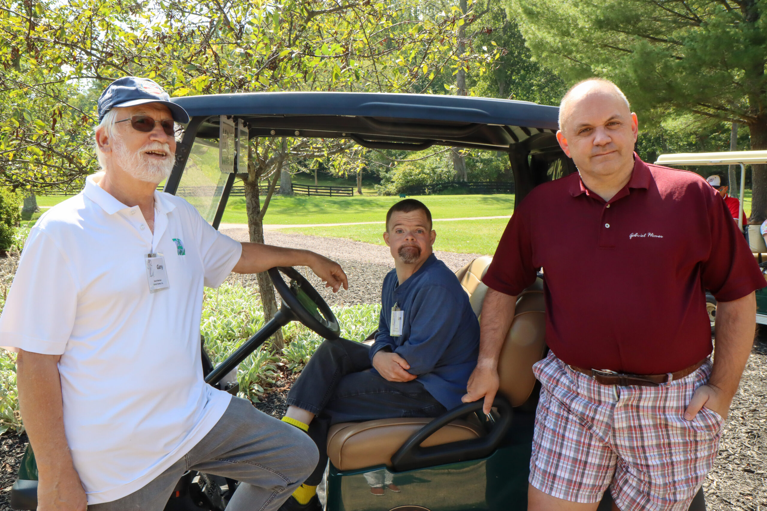 Gabriel Homes board member Gary (left) with two residents, including his son (center).