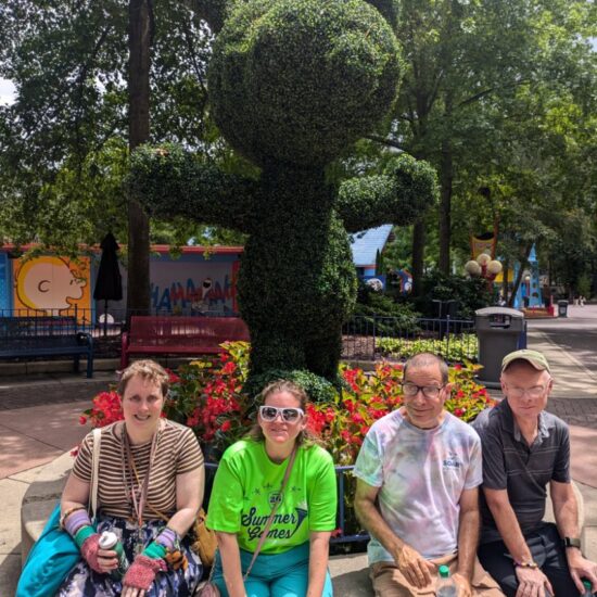 Gabriel Homes resident in front of a Snoopy bush at Kings Dominion.