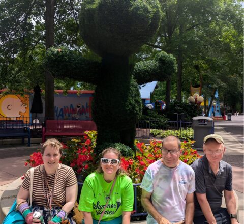 Gabriel Homes resident in front of a Snoopy bush at Kings Dominion.