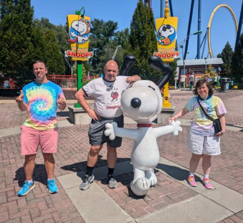 Gabriel Homes residents posing with Snoopy at Kings Dominion.