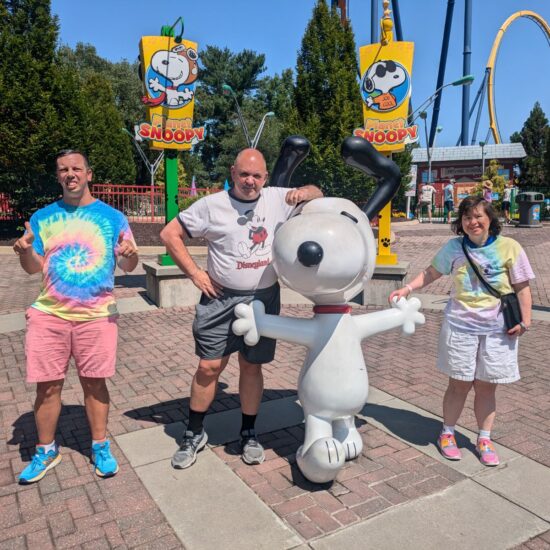 Gabriel Homes residents posing with Snoopy at Kings Dominion.