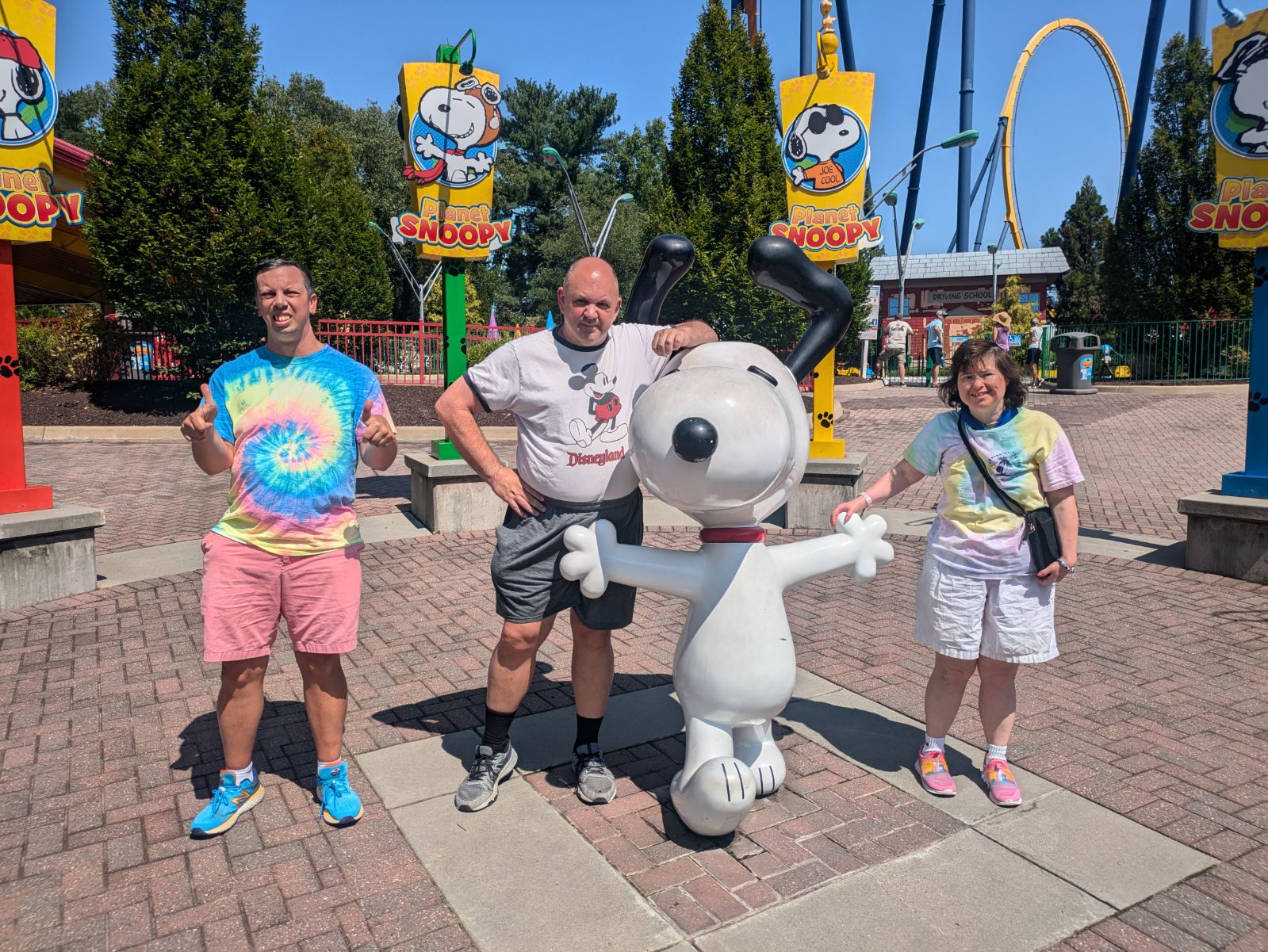 Gabriel Homes residents posing with Snoopy at Kings Dominion.