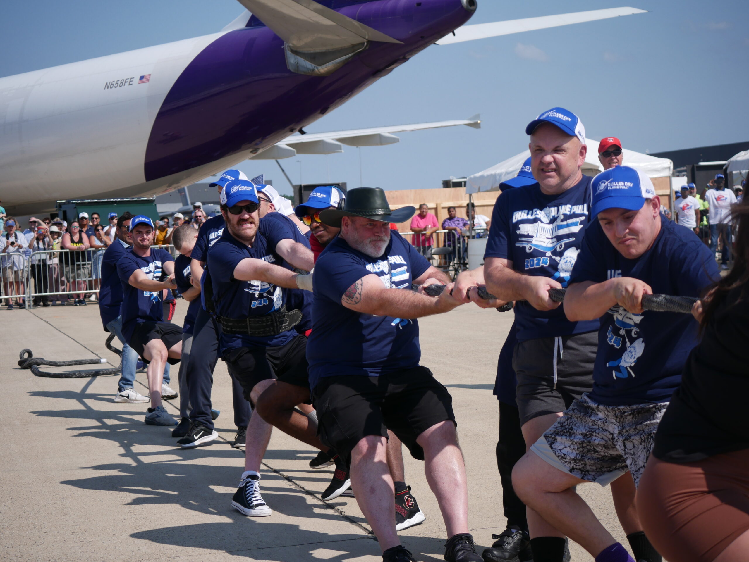 Gabriel Homes powerlifters pulling a plane at Dulles Airport.