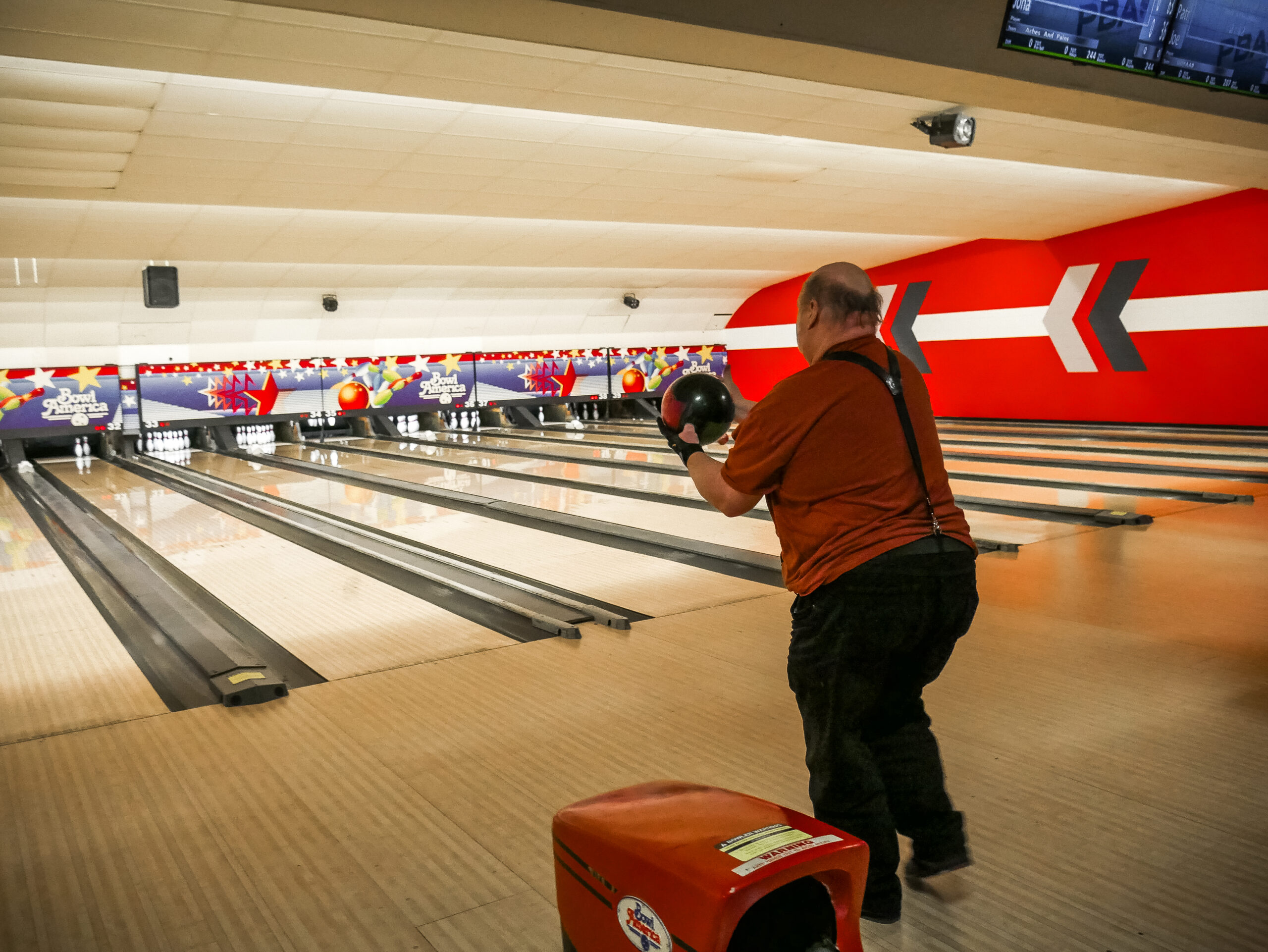 Gabriel Homes resident holding bowling ball. The sport boosts physical and mental health.