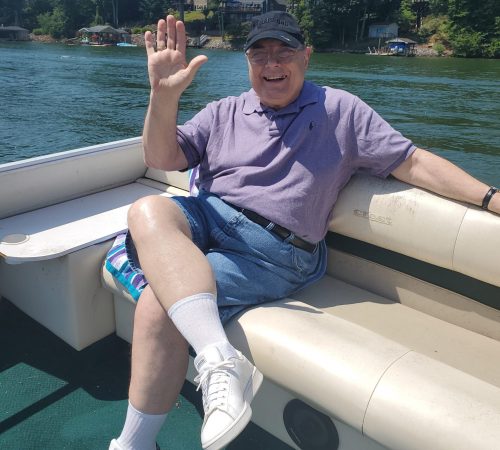 Gabriel Homes resident sitting on a boat on a local lake.