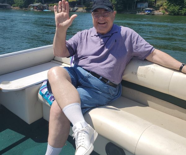 Gabriel Homes resident sitting on a boat on a local lake.