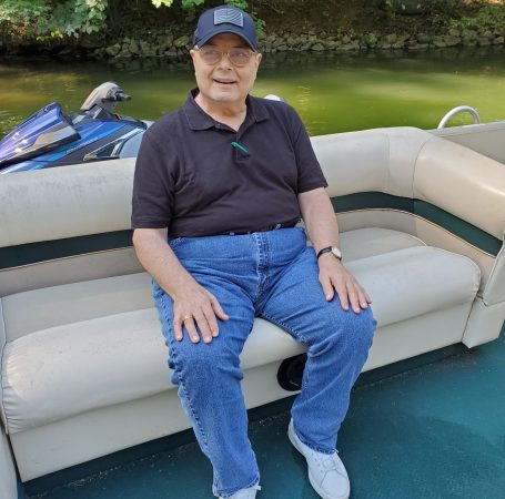 Gabriel Homes resident sitting on a boat at a local lake.