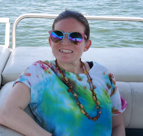 Gabriel Homes resident on a boat at a lake.