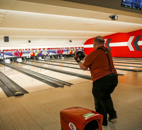 Gabriel Homes resident holding bowling ball. The sport boosts physical and mental health.