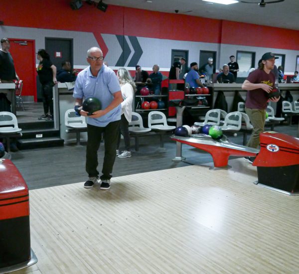 Gabriel Homes resident holding bowling ball. The sport boosts physical and mental health.