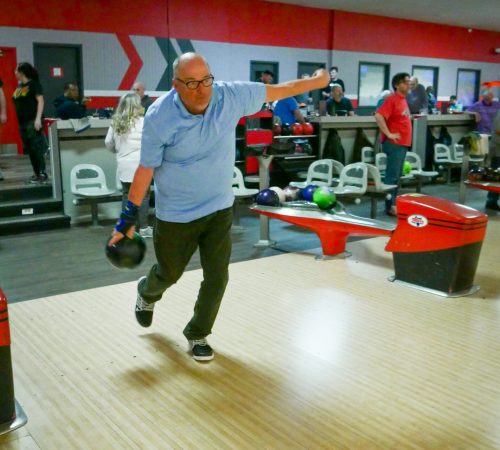 Gabriel Homes resident holding bowling ball. The sport boosts physical and mental health.