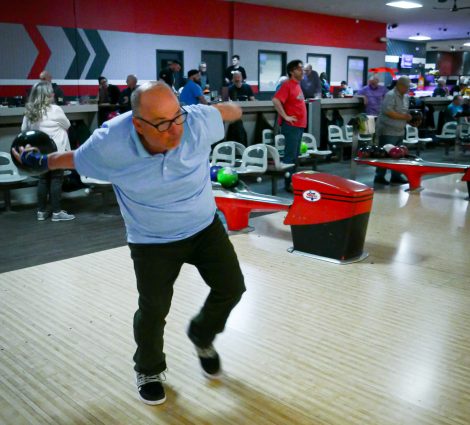 Gabriel Homes resident holding bowling ball. The sport boosts physical and mental health.