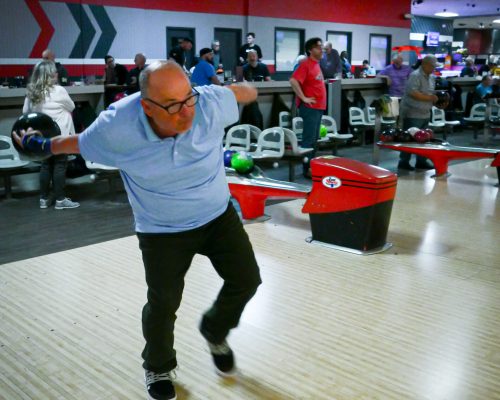 Gabriel Homes resident holding bowling ball. The sport boosts physical and mental health.