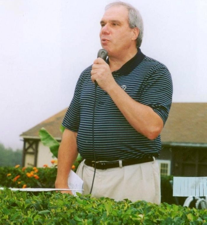 Reverend Monsignor Bob Cilinski delivering remarks at the Gabriel Homes golf tournament.