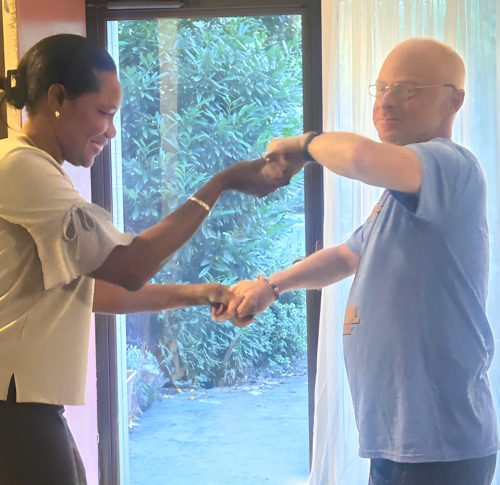 Gabriel Homes staff (left) dancing with resident at surprise birthday party.