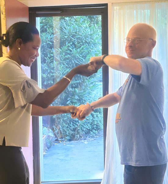 Gabriel Homes staff (left) dancing with resident at surprise birthday party.