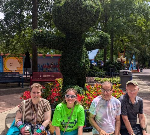 Gabriel Homes resident in front of a Snoopy bush at Kings Dominion.